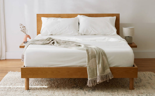 A beautiful Koala bed with clean, white cotton sheets and a throw