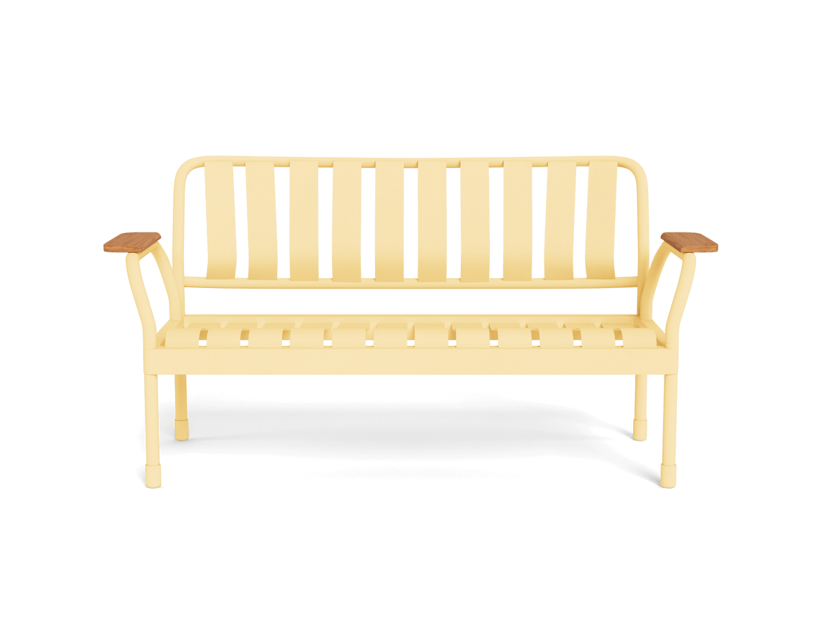 Yellow metal outdoor bench with wooden armrests and a slatted back and seat, casting a shadow on a white background.