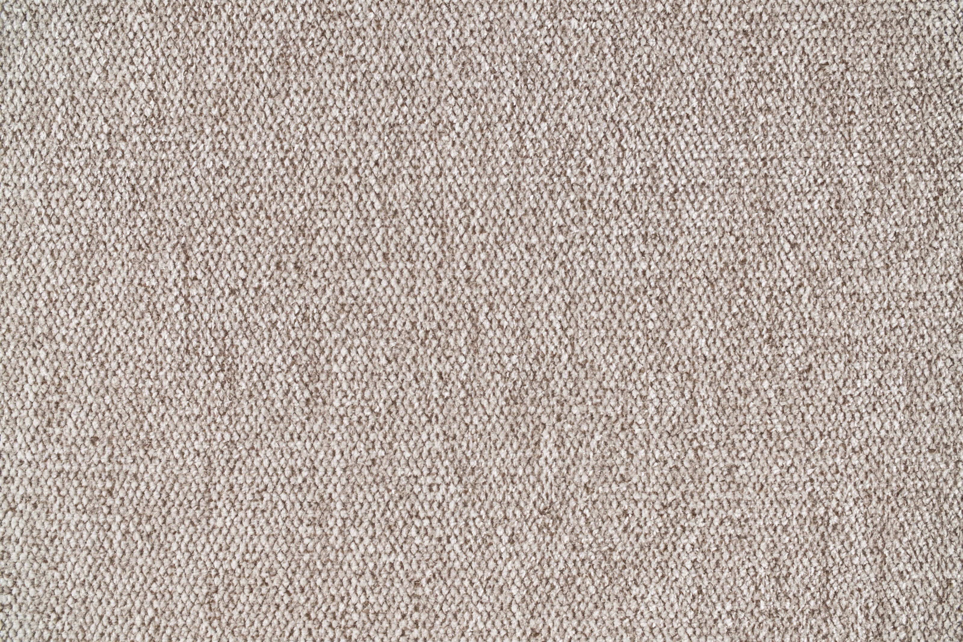 Close-up of light brown textured fabric with a woven pattern, suitable for upholstery or curtains.