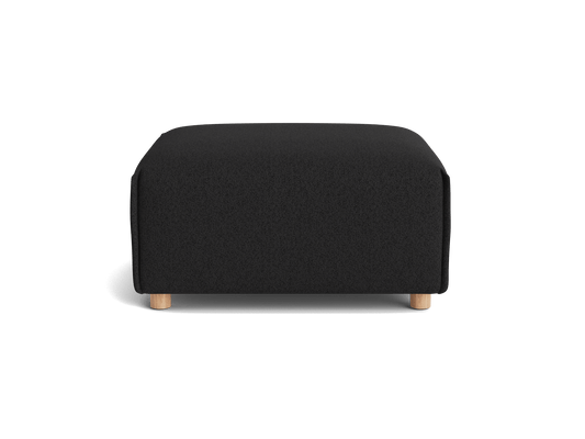 A black ottoman with a rectangular shape and wooden legs.