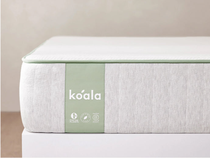 Light grey mattress with a pale green side panel featuring white "koala" branding; minimalist and eco-friendly design.