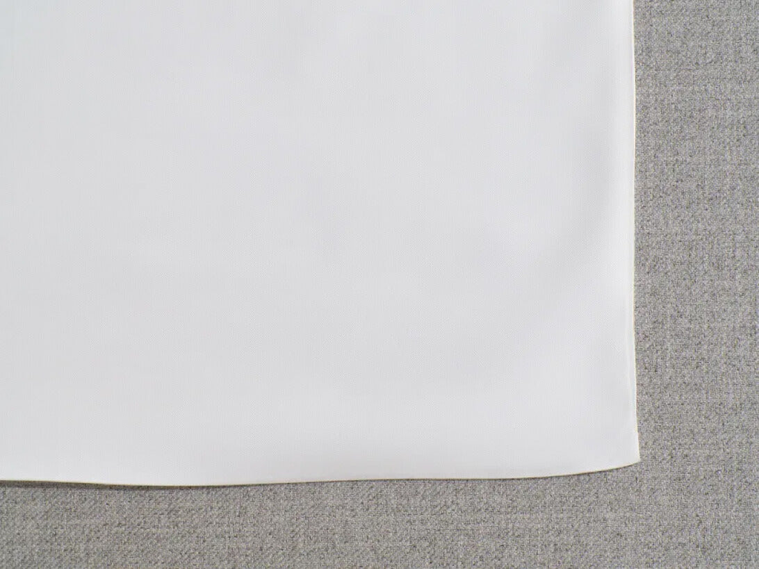 Close-up of white fabric over light grey textured fabric, showcasing a minimalistic design. Ideal for furniture, upholstery, or textiles.