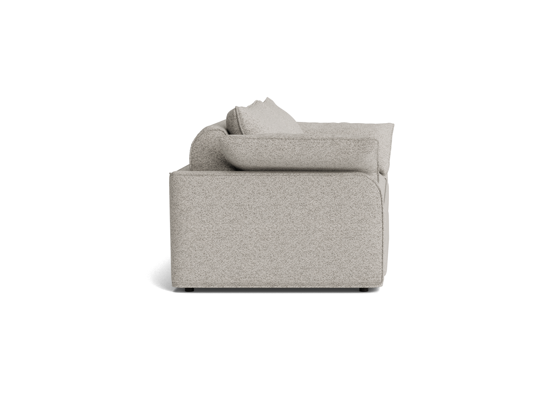 Side view of a light grey couch with plush cushions and a boxy design. Simple, modern furniture style.