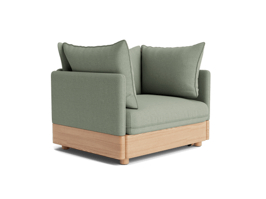 Light green corner sofa chair with two cushions, featuring a wooden base.