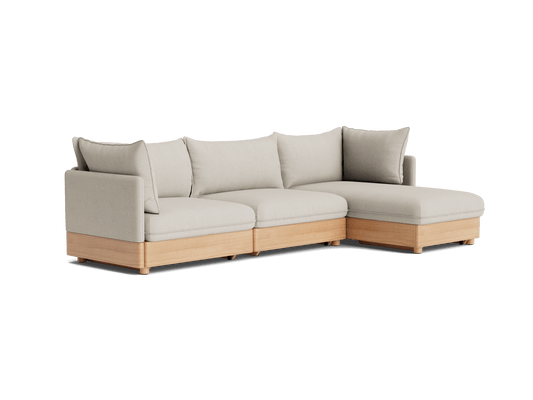 Light grey L-shaped sectional sofa with wooden base, featuring plush cushions and a clean, modern design. Perfect for stylish living spaces.