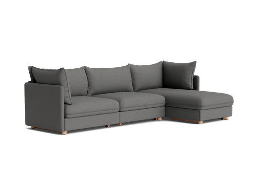 Dark grey L-shaped sectional sofa with wooden legs and plush cushions, perfect for modern living room comfort.