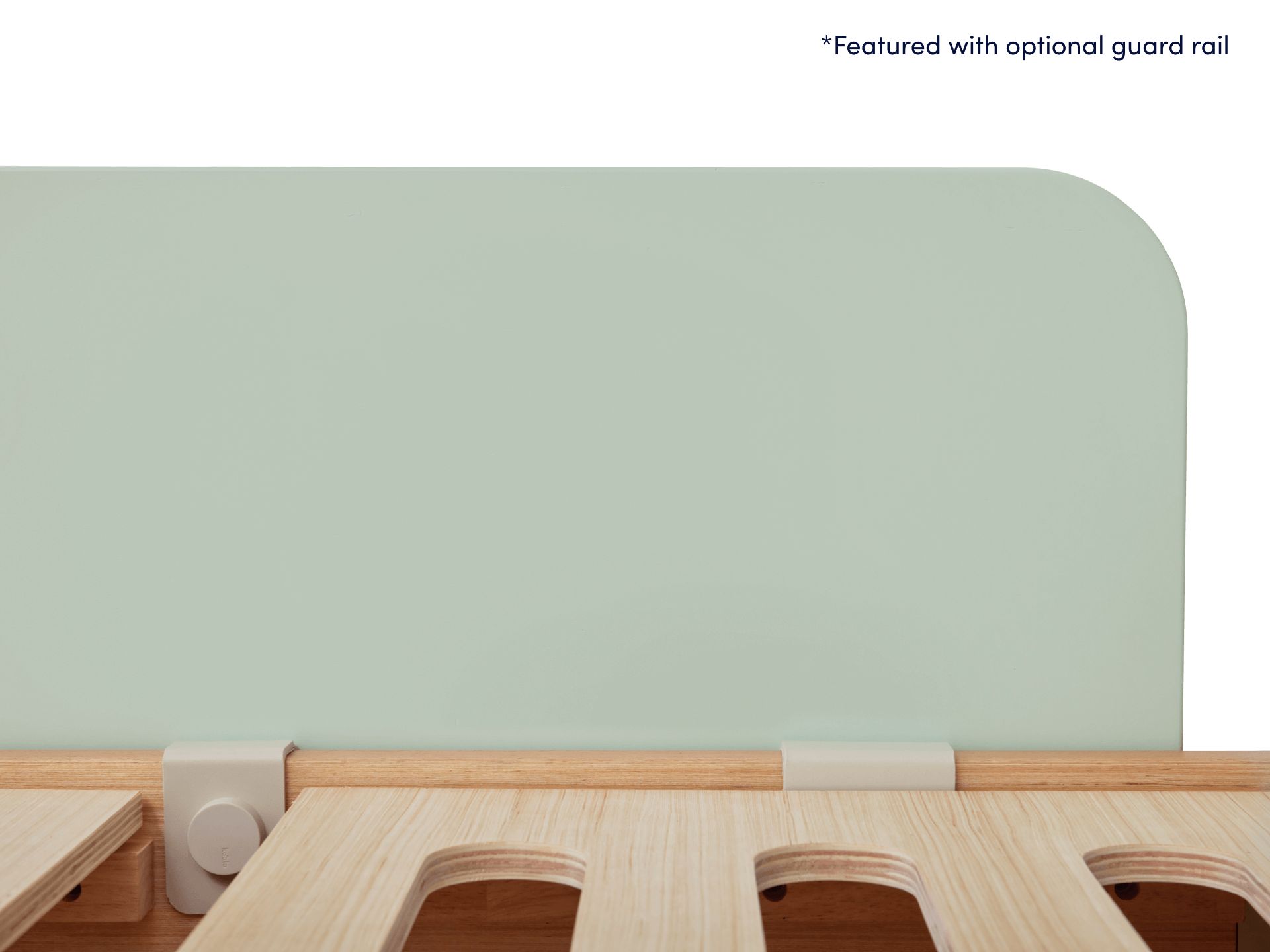Light wooden bed frame with slatted base and mint green guard rail.
