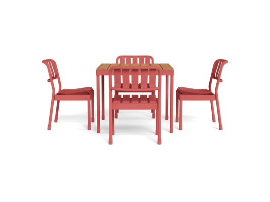 Four coral chairs with slatted backs surround a wooden dining table, creating a vibrant and modern outdoor furniture set.