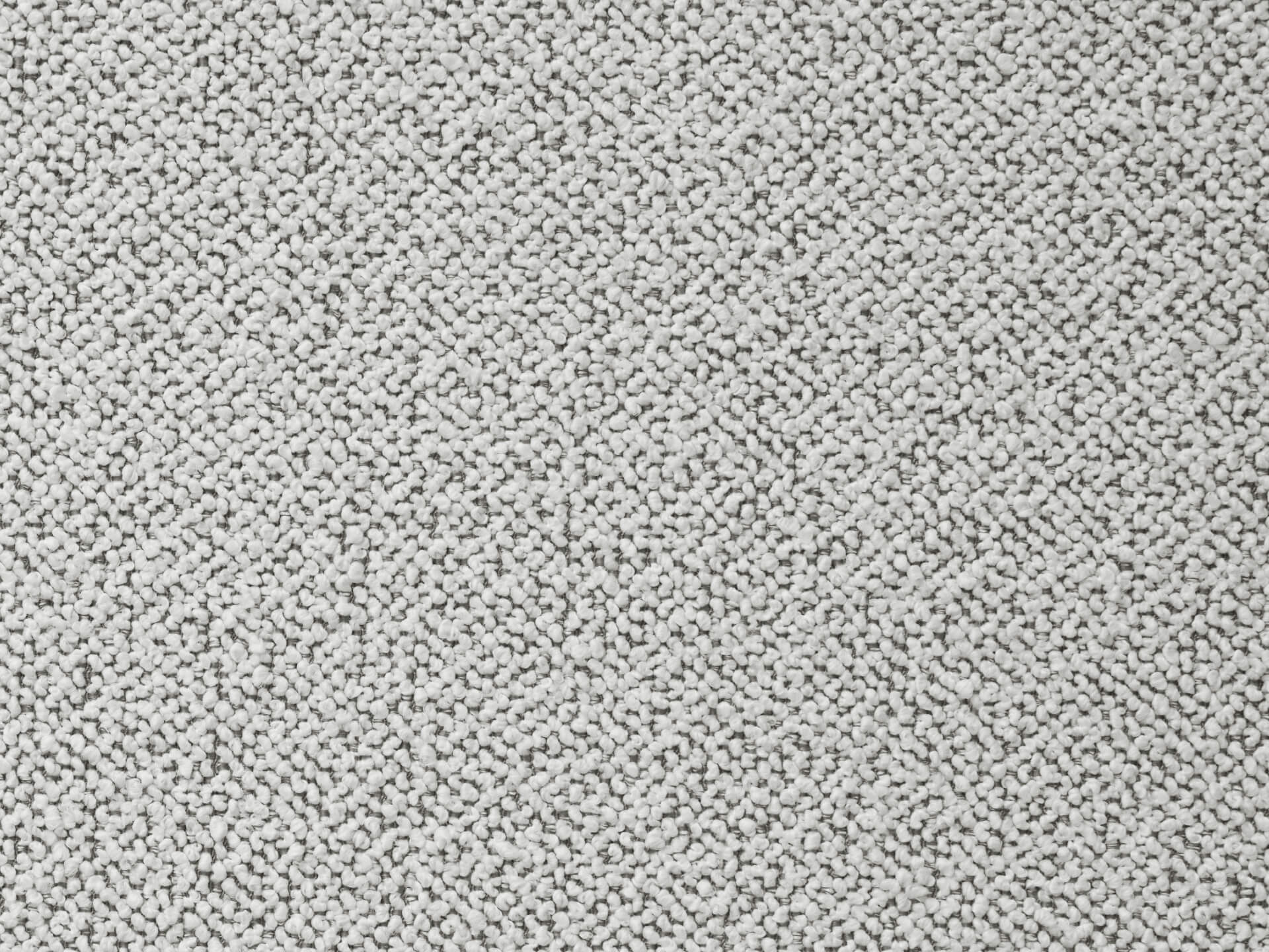 Close-up of a light grey textured fabric with a subtle zigzag pattern, ideal for upholstery or home decor.