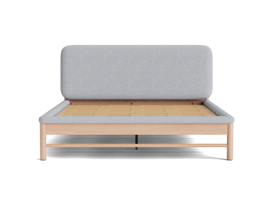 Light grey upholstered bed with a wooden frame, featuring a tall headboard and slatted base. Simple modern design.