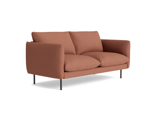 Light brown sofa with plush cushions and sleek black legs, set against a white background.