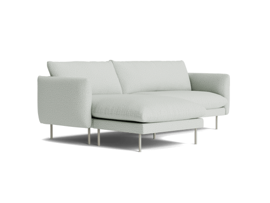 Light grey sectional sofa with plush cushions and metal legs, featuring a chaise lounge on the right side. Modern and minimalist design.