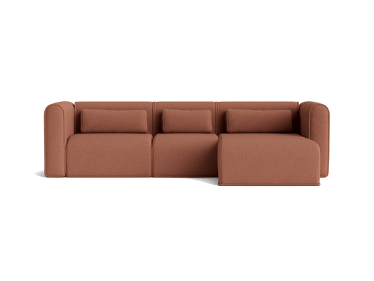 Rust brown modular sectional sofa with three cushions and a chaise lounge. Modern design suitable for any living room.