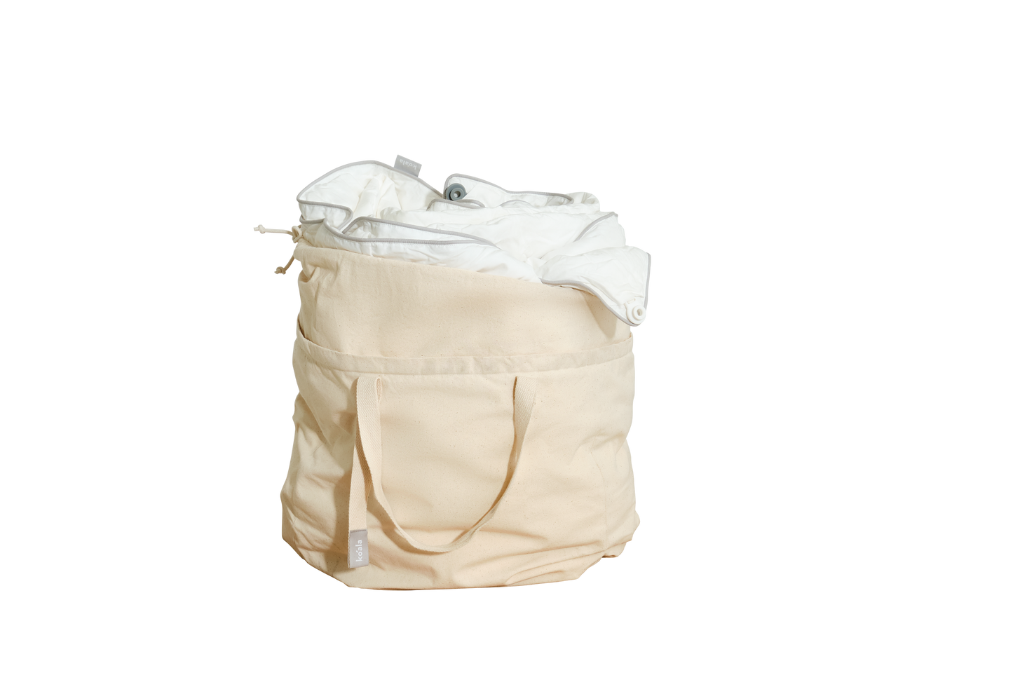 Beige canvas laundry bag filled with white fabric, featuring handles and an external pocket.