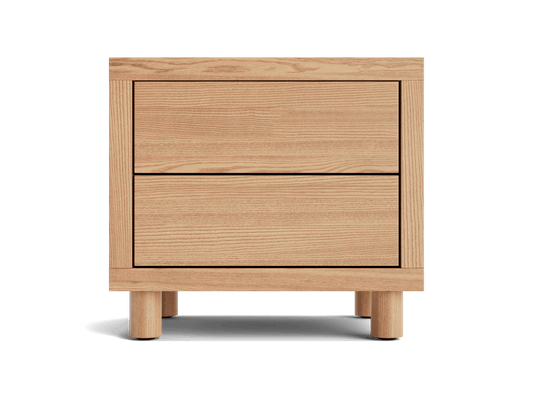 Wooden bedside table with two drawers and round legs in light brown finish.