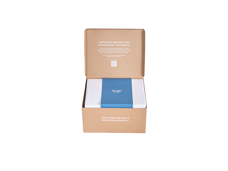 Open cardboard box with a blue and white folded package inside. White text is printed on the inside lid of the box.