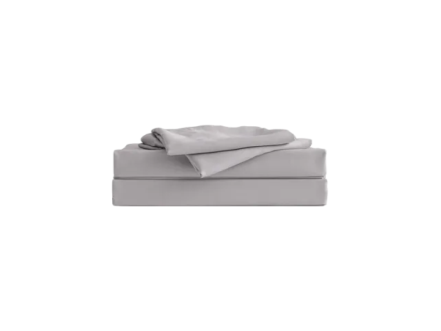 Folded light grey bed sheet set neatly stacked on a white background. Perfect for bedroom decor and bedding design.