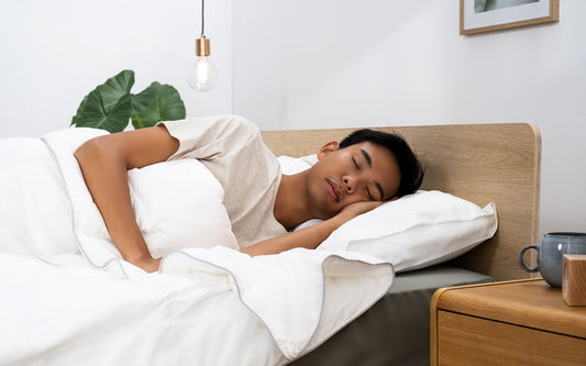 A young man in his favourite sleeping position relaxes under a Koala duvet