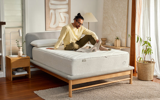 A man relaxes on his Koala mattress as he contemplates what time he should go to bed