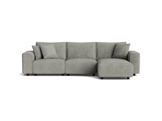 Light grey modular sofa with chaise lounge on the right, three cushions, and plush armrests, perfect for modern living rooms.