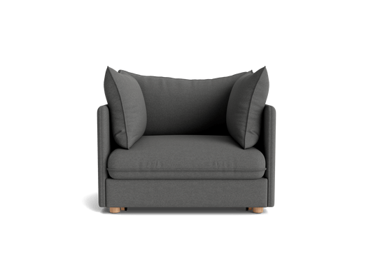 Dark grey armchair with two large cushions, wooden legs, and a modern design, perfect for stylish living room seating.