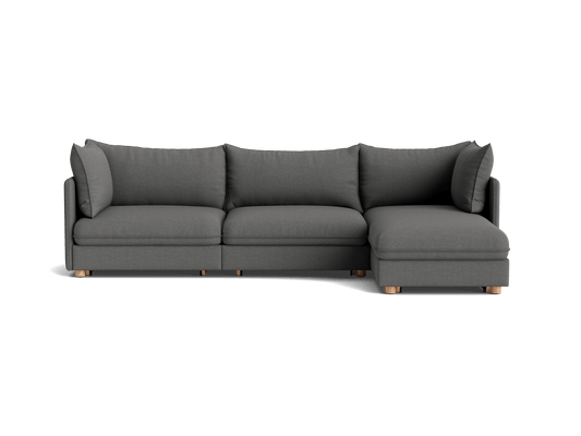 Dark grey L-shaped sectional sofa with plush cushions and wooden legs. Suitable for modern living rooms.