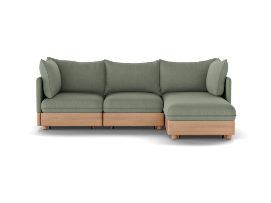 Green L-shaped sofa with wooden base, featuring three cushion seats and a chaise. Modern design; functional and stylish living room furniture.