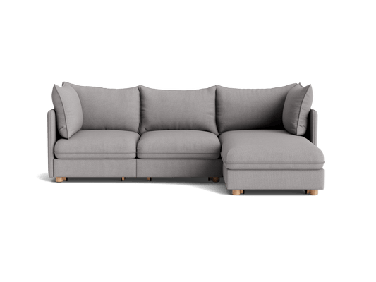 Light grey L-shaped sectional sofa with cushioned seating and wooden legs. Perfect for modern living rooms.