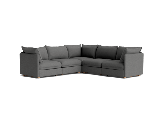 Dark grey L-shaped sectional sofa with plush cushions and wooden legs. Modern design, perfect for living room comfort and style.