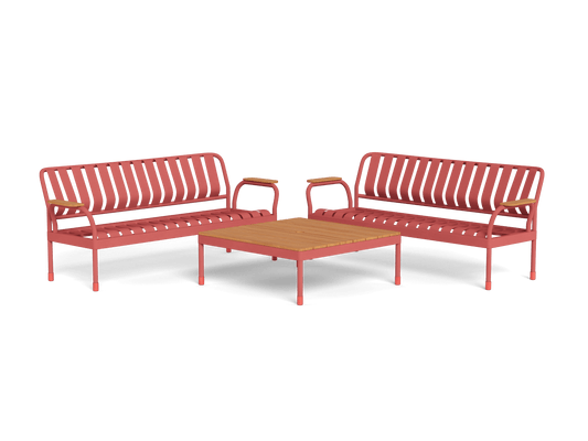 Two red metal outdoor benches with slatted backs and seats flank a square wooden coffee table. Perfect patio furniture set.