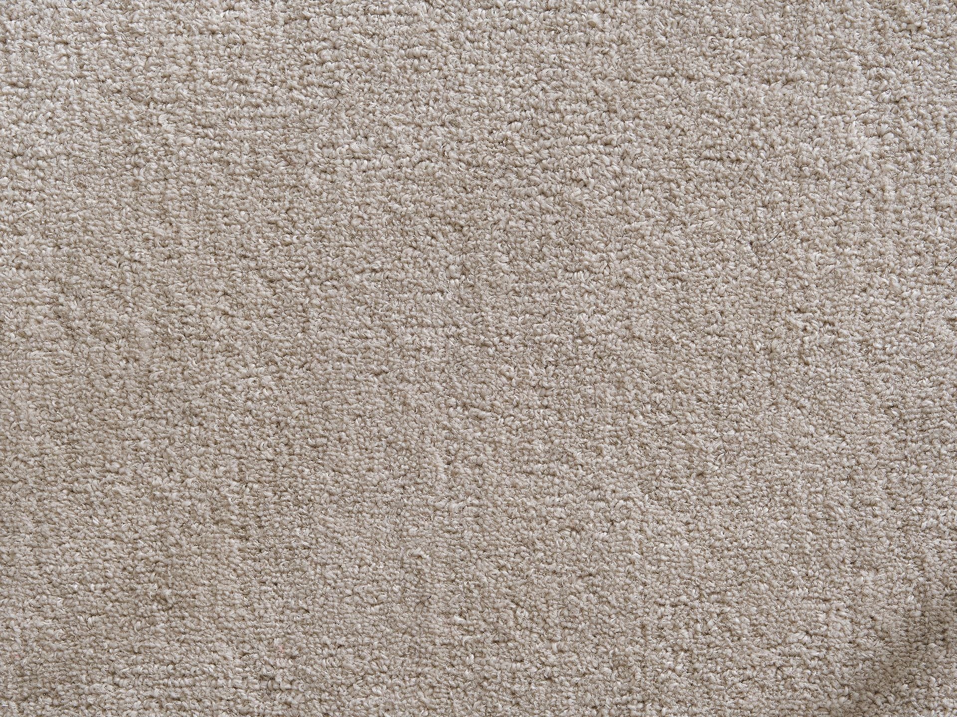 Beige carpet texture with a soft, plush surface. Ideal for home flooring, offering comfort and a neutral aesthetic.