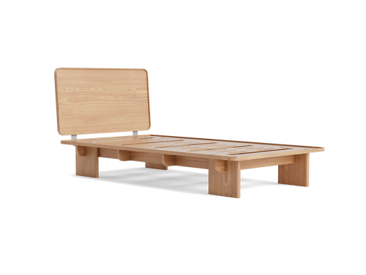 Minimalist light wood platform bed frame with a raised headboard.