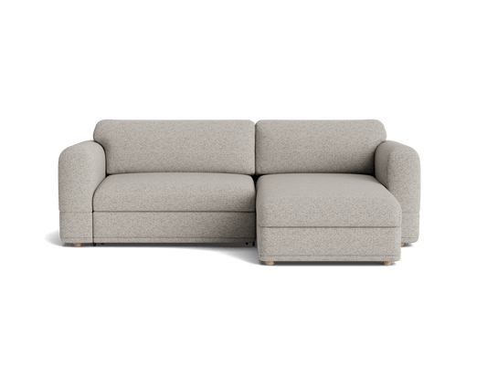 Light grey L-shaped sofa with rounded arms and plush cushions, sitting on small wooden legs. Perfect for modern living rooms.