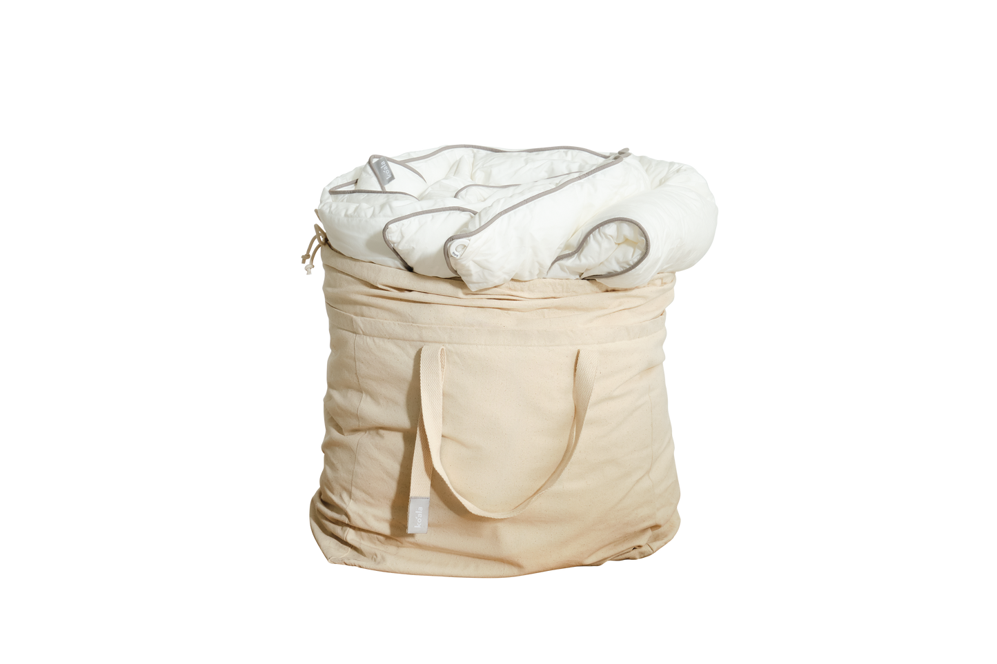 A beige fabric storage bag with handles, containing a white rolled-up quilt.