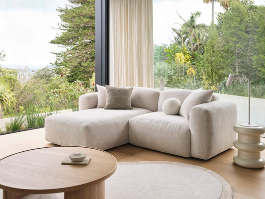 Light grey Koala modular sofa with chaise in sunlit living room with floor-to-ceiling garden views
