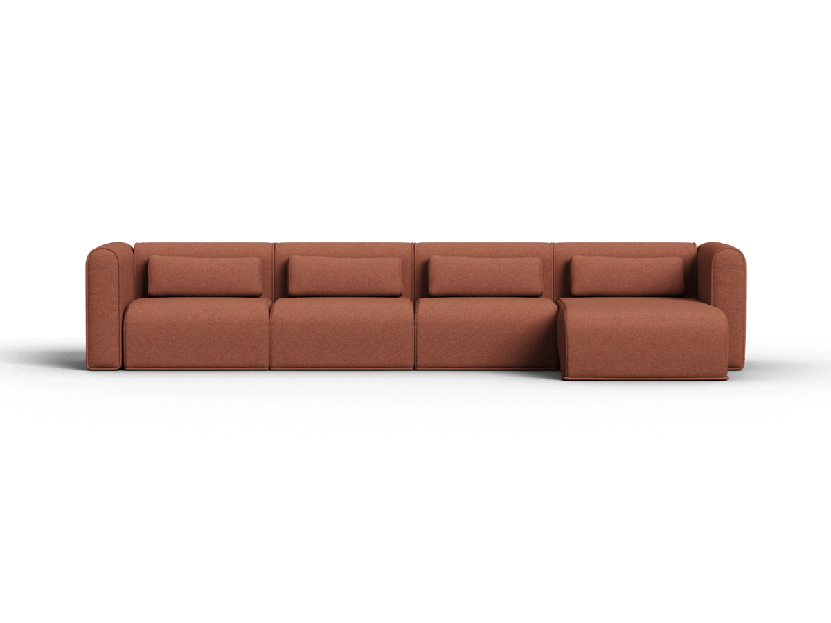 Wide sectional sofa in warm brown fabric with square seat cushions and a chaise on the right side on black background