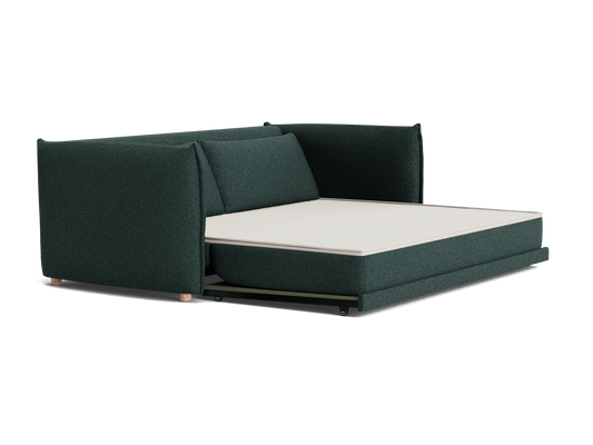 Dark green modular sofa bed with a light-coloured mattress, featuring a simplistic and modern design.