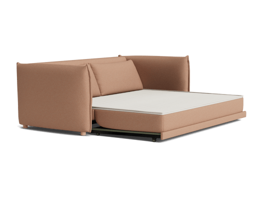 Beige sofa bed with cushioned backrest, featuring an extended white mattress. Simple and functional furniture design.