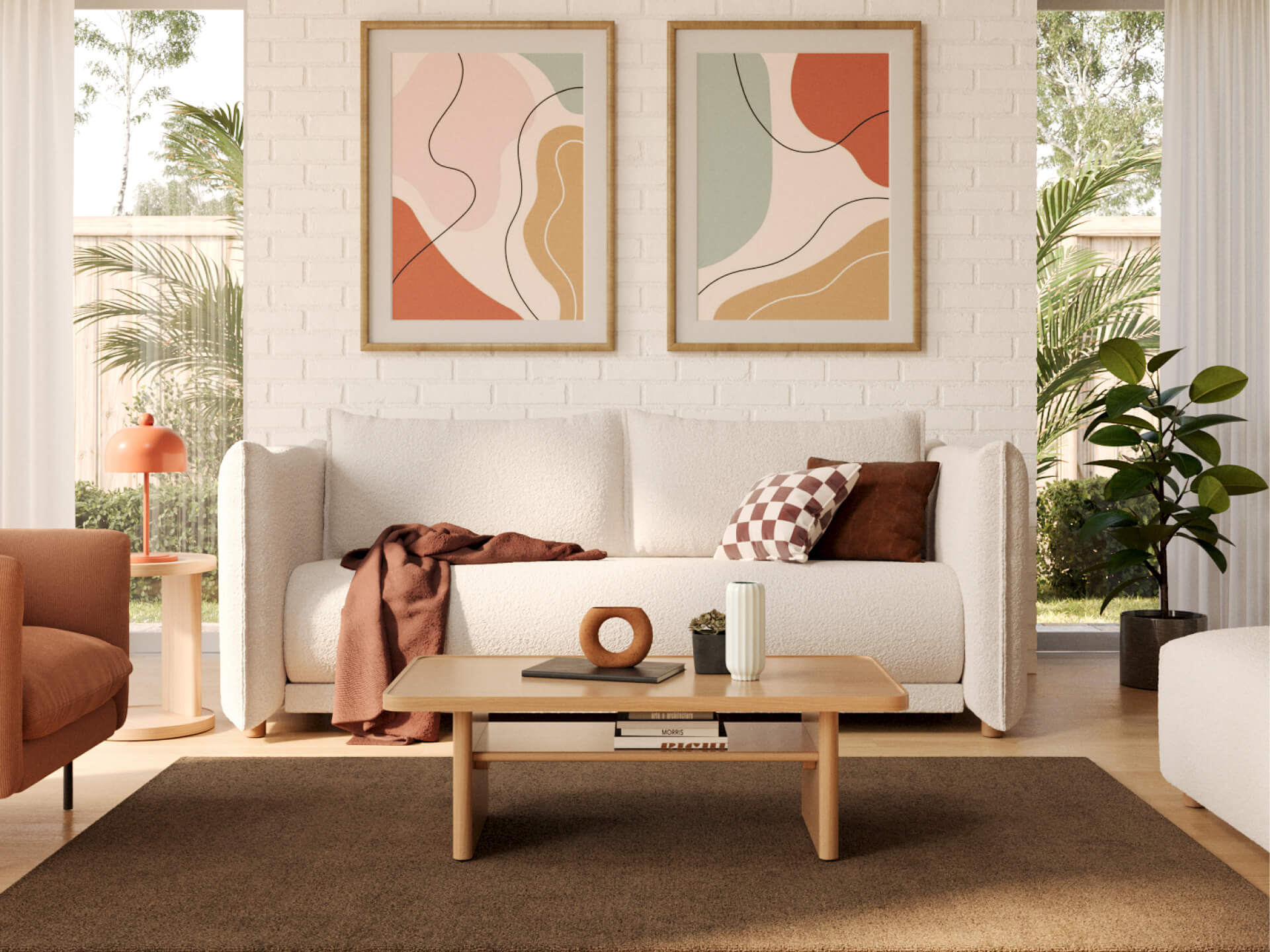 A light grey couch with brown and white cushions sits against a white brick wall. Two abstract paintings hang above. A wooden coffee table is in front, atop a brown rug.