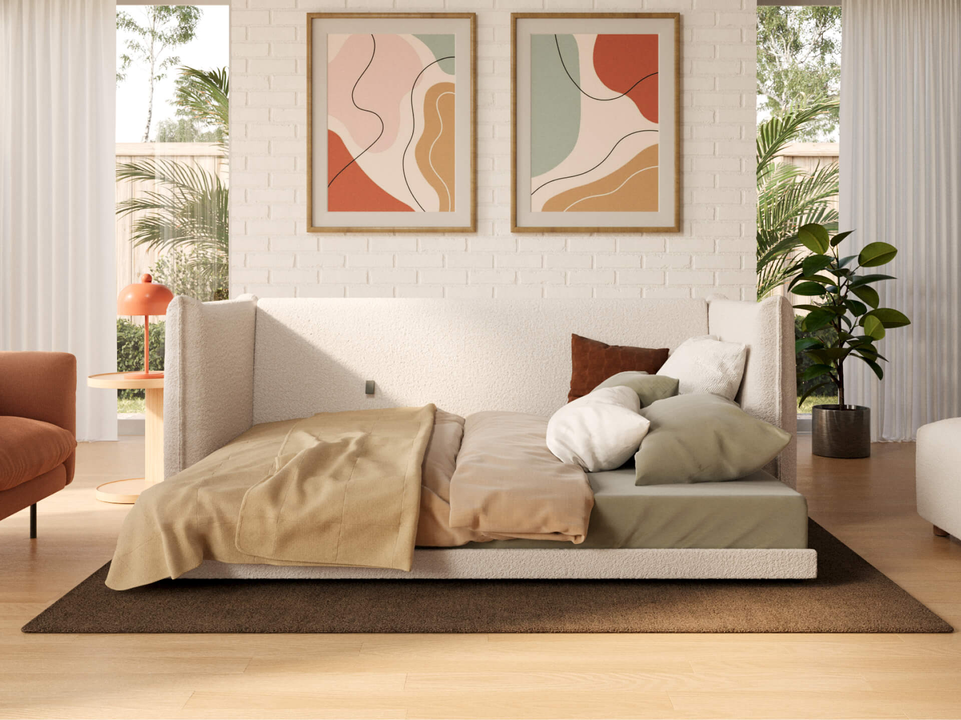 Modern living room with a white daybed, green and beige bedding, abstract art on a white brick wall, and greenery. Light wooden floor.