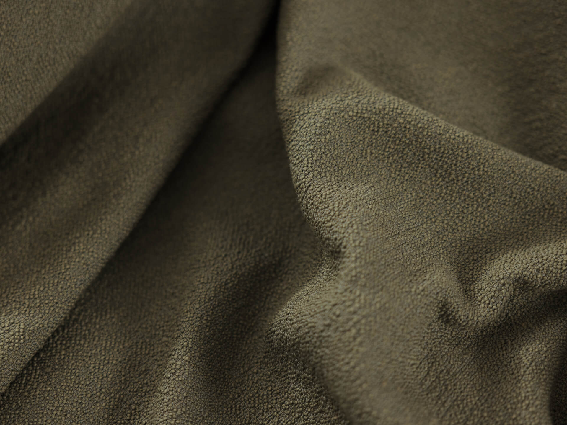 Olive green textured fabric, draped with soft folds; ideal for upholstery or curtains.