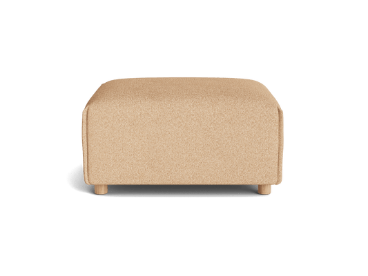 Tan fabric ottoman with a rectangular shape, flat top, and short legs, viewed from the front against a white background.