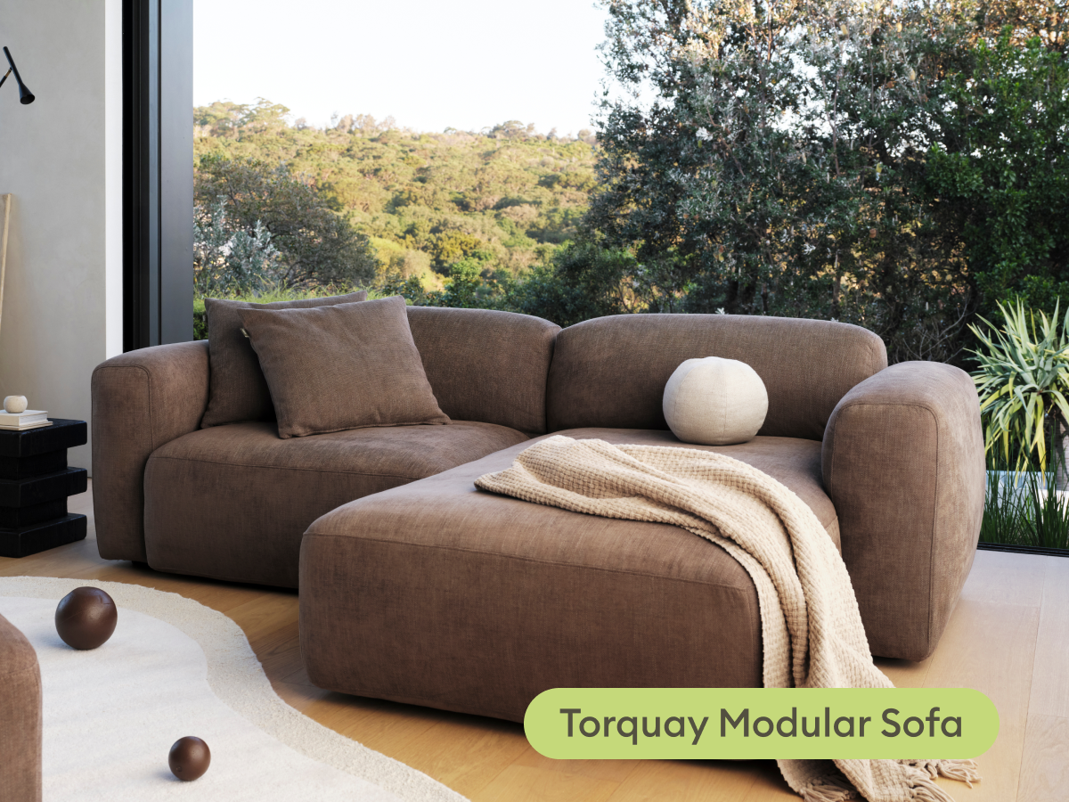 Koala Torquay Modular Sofa in taupe with ottoman and throw in living room with bushland view