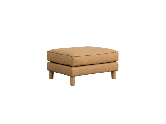 A tan ottoman with wooden legs, featuring a simple, square design and cushioned top. Suitable as a footrest or extra seating.