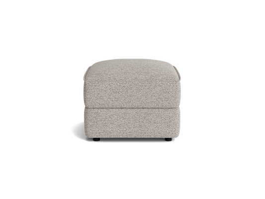 Light grey upholstered ottoman with a square shape, visible stitching, and subtle texture. Ideal for modern living room decor.