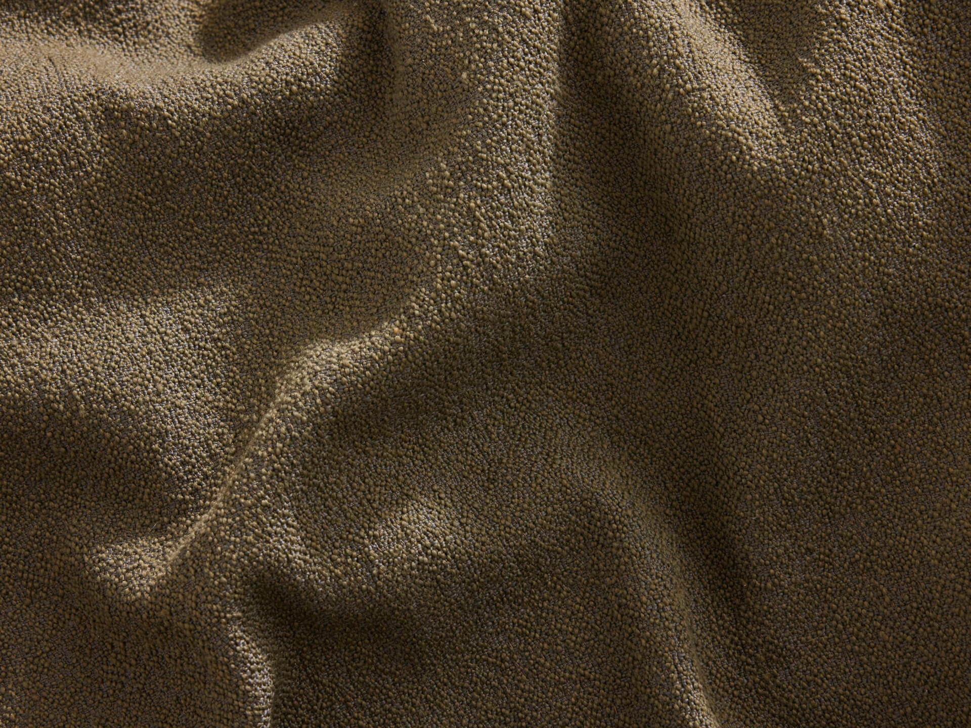 Textured dark brown fabric with soft, subtle wrinkles. Ideal for upholstery or home decor.