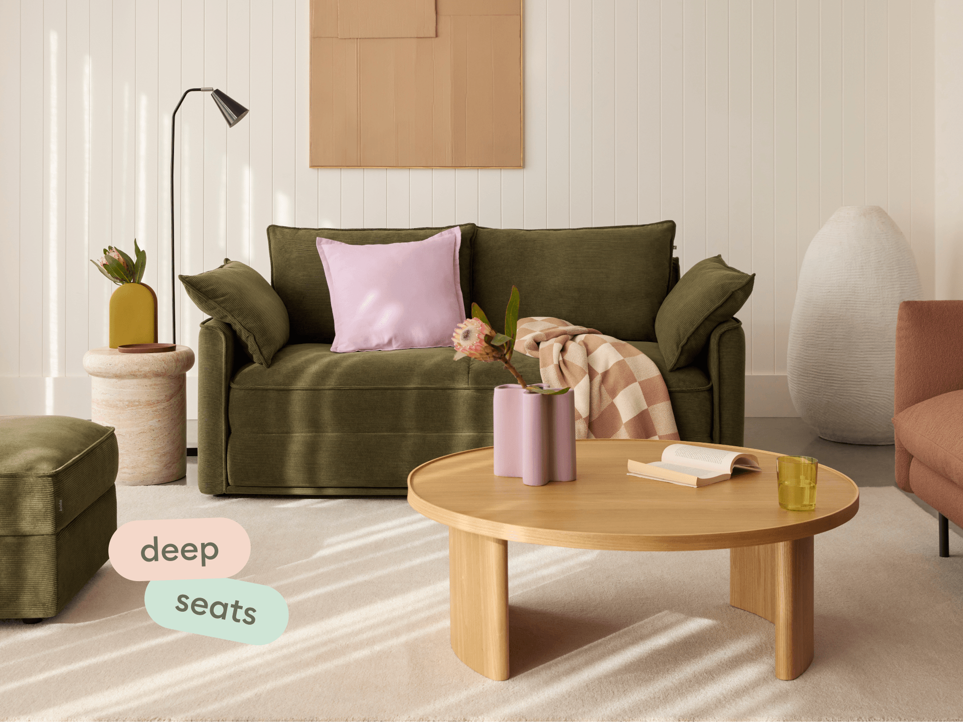 Man lounging on Koala Sofa Bed Double in olive green corduroy with deep seats text overlay overhead view