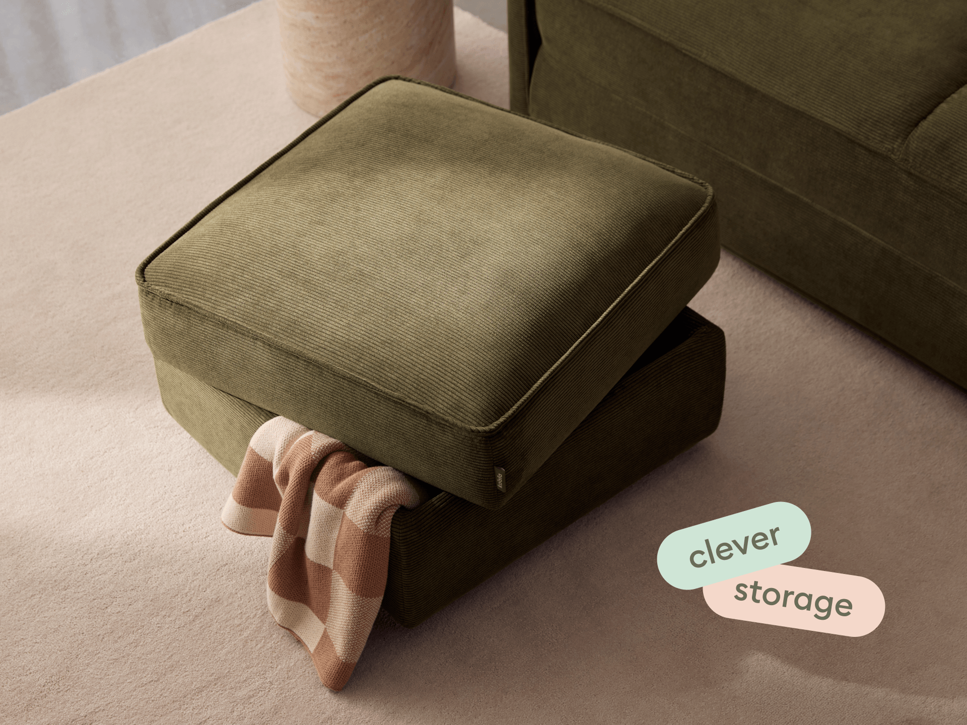 Koala Sofa Bed Ottoman in olive green corduroy in styled living room with matching sofa