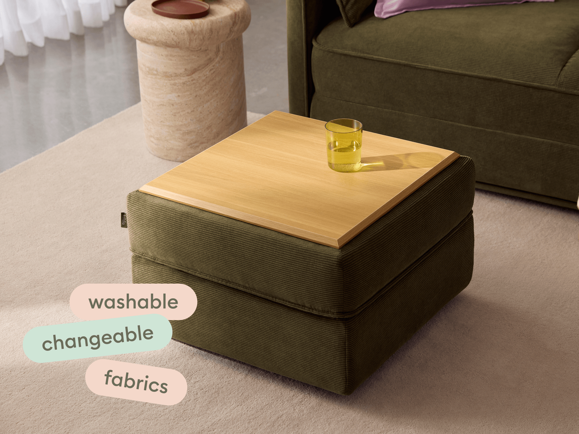 Koala Sofa Bed Ottoman in olive green corduroy close-up detail with pink cushion in styled setting