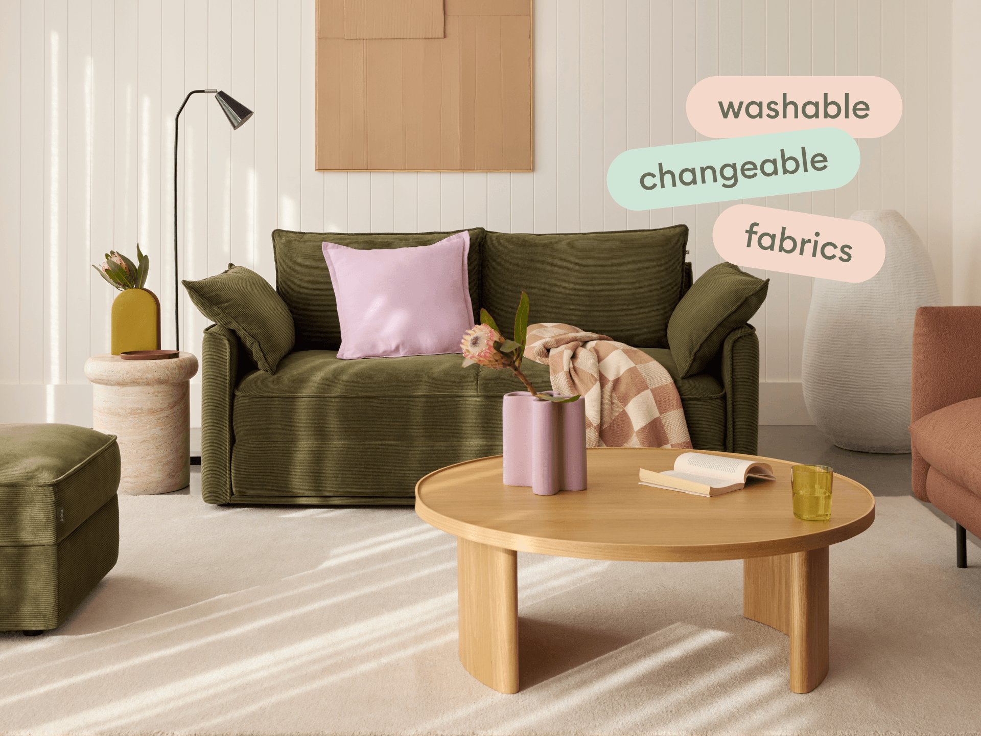 Koala Sofa Bed Single in olive green corduroy close-up detail with pink cushion in styled setting